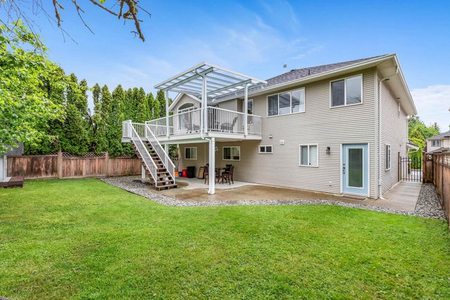 Back of property with a pergola, a wooden deck, stairs, and a patio area | Image 28