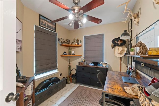 Home office with light tile patterned floors and ceiling fan | Image 17