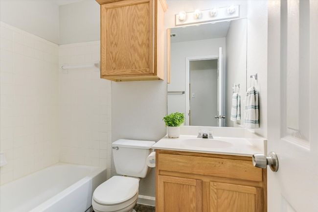 Full secondary bathroom with shower / bathing tub combination, toilet, and vanity | Image 14