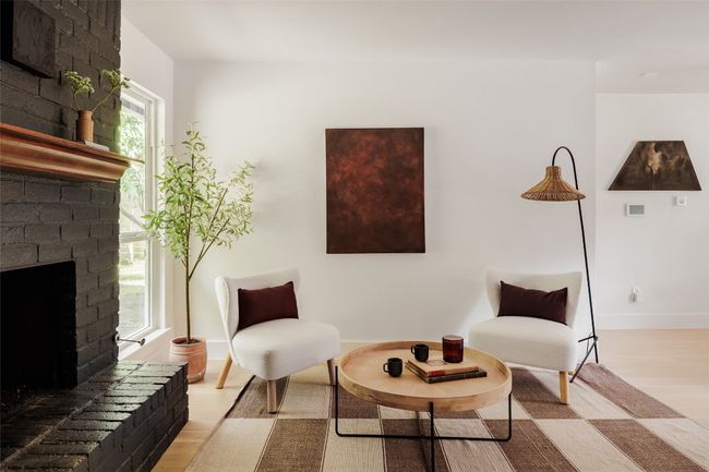Living area featuring light wood-style floors and a brick fireplace | Image 10