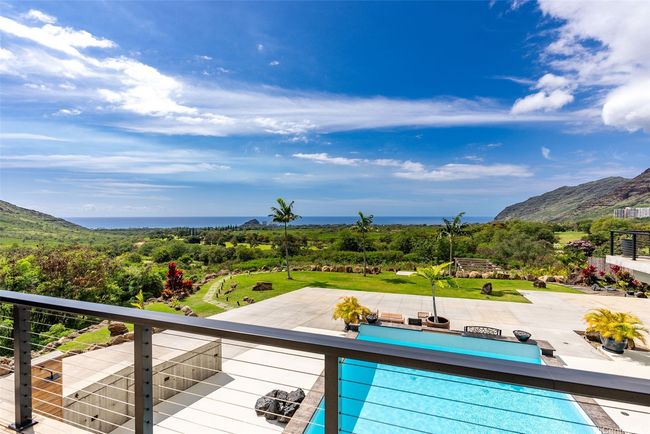 View of pool that has integrated hot tub, outdoor shower, deck, walking path to terraced lower acreage, you can see trellis towards the right and there is much more land below, including *helipad! | Image 4