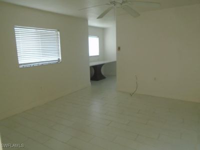 Tiled empty room featuring ceiling fan | Image 3