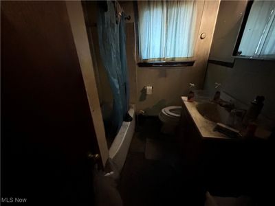 Full bathroom featuring shower / tub combo with curtain, vanity, and toilet | Image 2