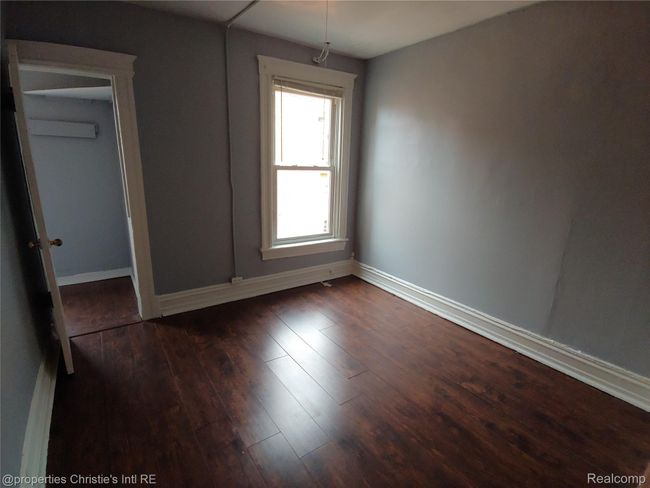 Spare room with baseboards and dark wood-style floors | Image 9