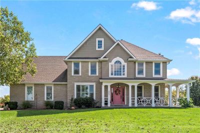 View of front of home with a walk around front porch | Image 1