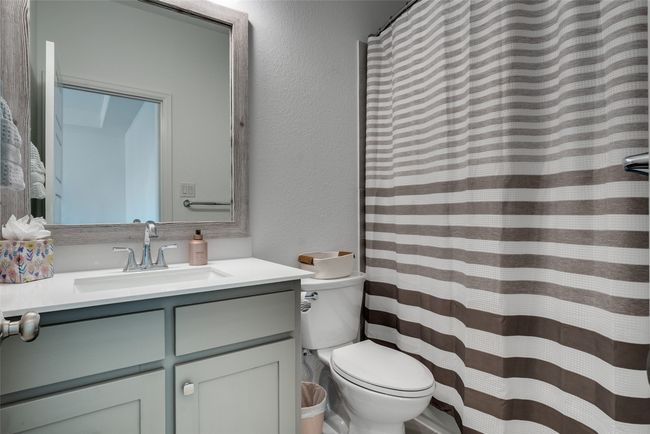 Full bathroom featuring vanity, a textured wall, and a shower with curtain | Image 12
