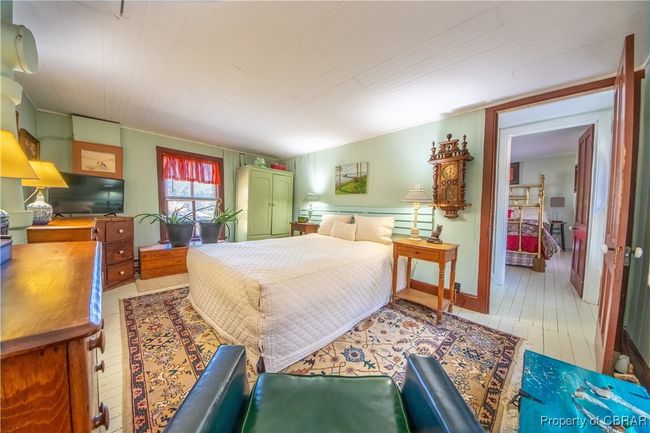 Bedroom with light wood-style flooring | Image 16