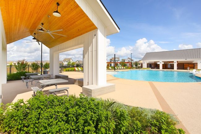 Community pool featuring fence, a patio, and a ceiling fan | Image 33