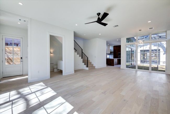 Spacious open living/dining/kitchen layout with a conveniently located downstairs powder bath. 10 foot ceilings, windows galore and beautiful white oak flooring. SEE VIRTUAL TOUR LINK WITH INTERACTIVE FLOOR PLAN AND 3D WALK THRU. | Image 17