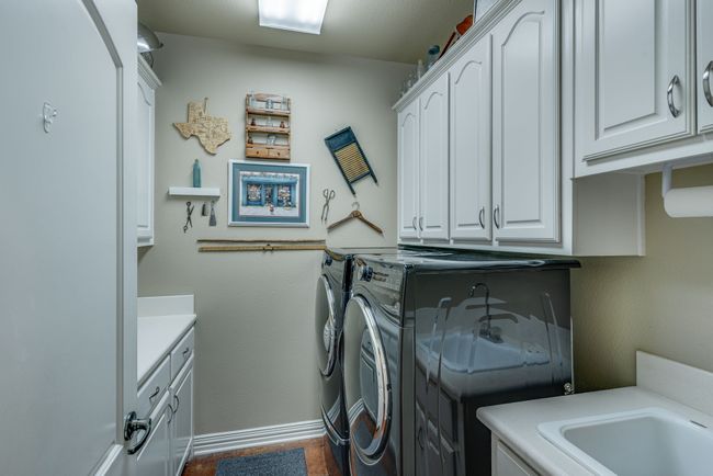 Laundry room with sink, counter space & cabinets | Image 16