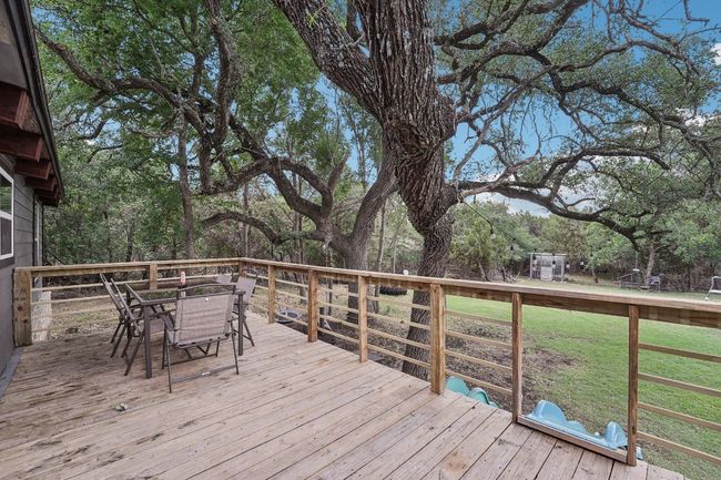Wooden terrace with outdoor dining space and a lawn | Image 24