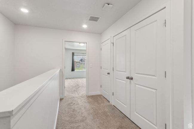 Hallway featuring light carpet, recessed lighting, and baseboards | Image 13