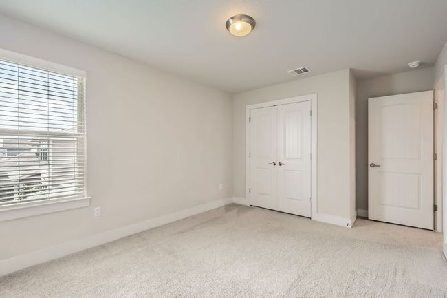 Unfurnished bedroom with light carpet, multiple windows, and a closet | Image 25