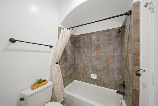 Included is a private water closet with a ceramic tile surrounded combination tub/shower & tile flooring. | Image 36