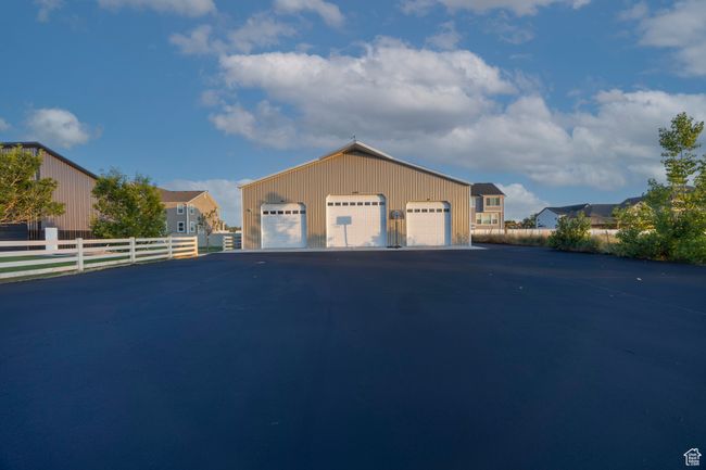 View of front of property with a detached garage and an outbuilding | Image 94