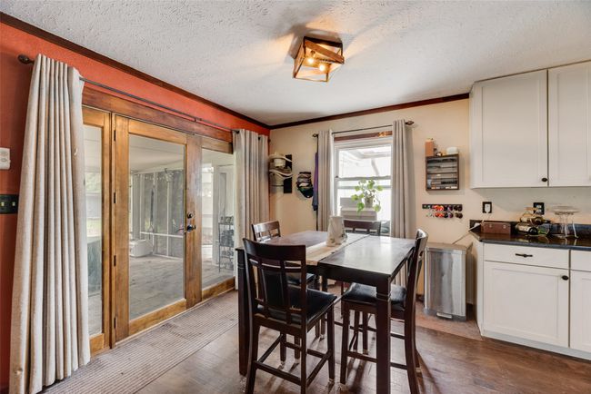 Dining room featuring crown molding, french doors, a textured ceiling, and dark wood-type flooring | Image 12