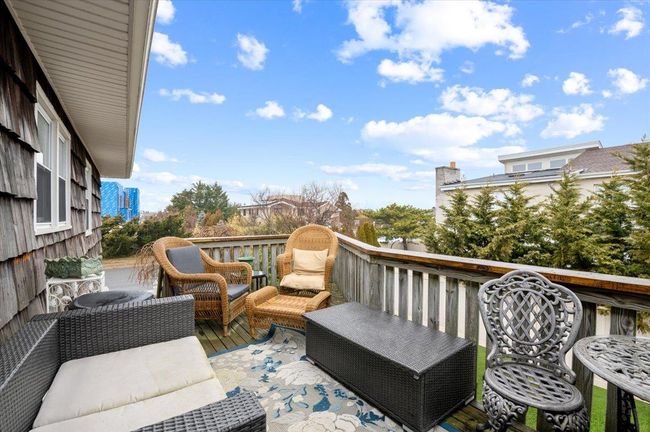 View of wooden balcony featuring an outdoor living space and a wooden deck | Image 28