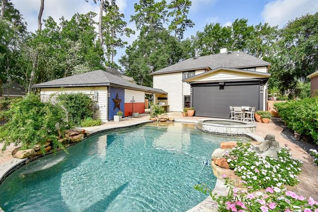 This backyard oasis includes a covered porch with remote control electric shades, outdoor kitchen, garden aarea and more! | Image 45