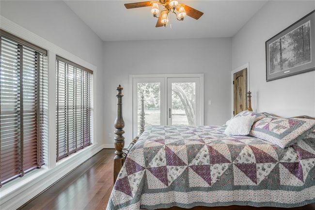 The second bedroom is equally as large, with french doors that lead out to the porch. It has a walk in closet, and lots of windows again to enjoy the view. | Image 25