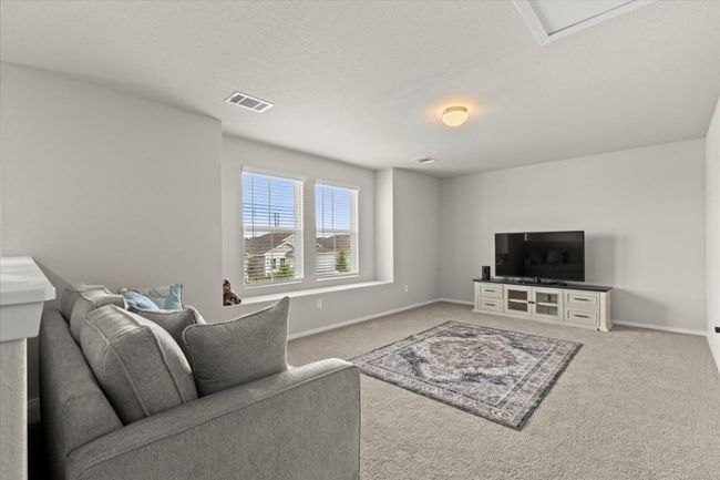 Carpeted living room featuring baseboards | Image 23