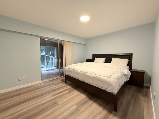 Bedroom with access to outside, wood finished floors, and baseboards | Image 15
