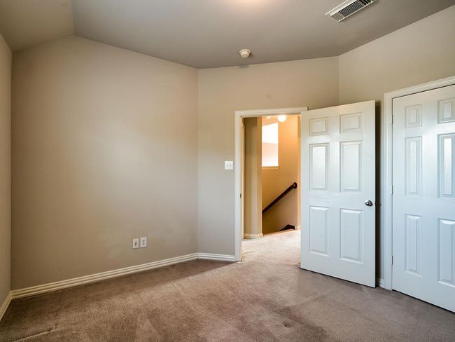 Unfurnished bedroom with carpet flooring, vaulted ceiling, and baseboards | Image 37
