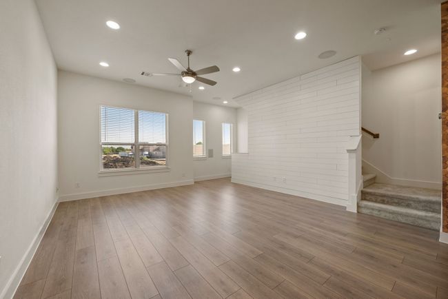 Unfurnished living room featuring visible vents, recessed lighting, wood finished floors, stairs, and ceiling fan | Image 14