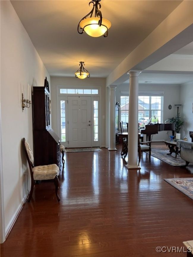 Entrance foyer with dark hardwood / wood-style floors and ornate columns | Image 15
