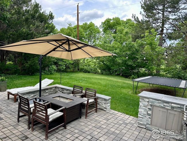 Custom-built in and stacked rock BBQ and patio for outdoor enjoyment | Image 21