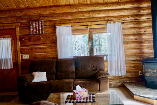 Living room featuring rustic walls, a wood stove, and wood ceiling | Image 36