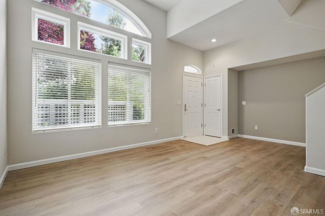 Lots of natural light floods the unit from the living room windows. | Image 11