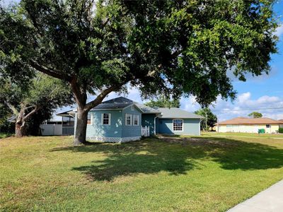 Several mature trees grace this .24 acre lot; storage shed | Image 3