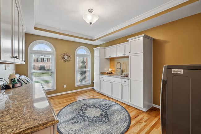 Previous owners converted the former dining room into a wonderfully functional laundry/multipurpose room. Current owners renovated with new cabinets, counters and a cast iron sink. | Image 17