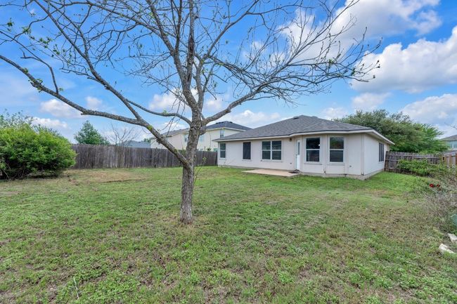 Back of house featuring a fenced backyard, a shingled roof, a patio, and a yard | Image 18