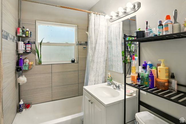 Bathroom featuring vanity and shower / bath combo with shower curtain | Image 13