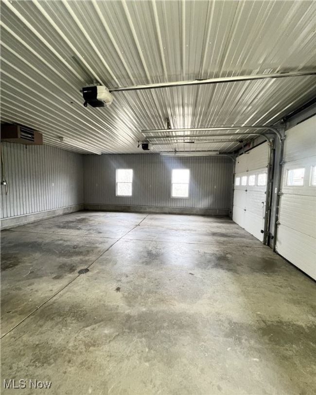 Garage featuring metal wall and a garage door opener | Image 22