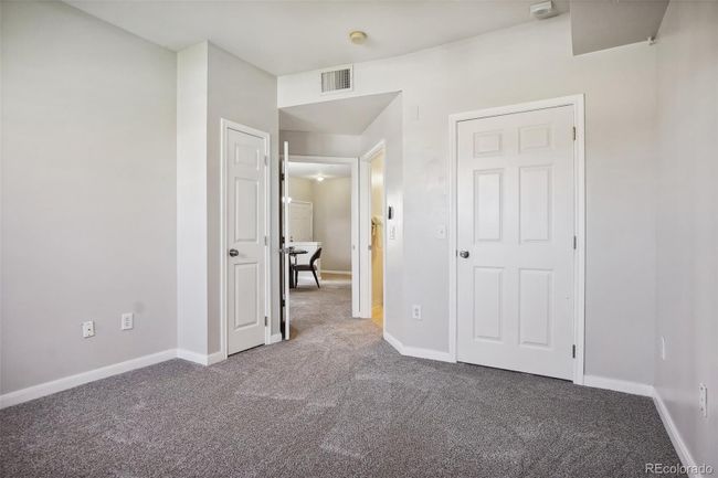 View from inside the primary bedroom looking out towards the walk-in closet, primary full bathroom and entryway. | Image 18