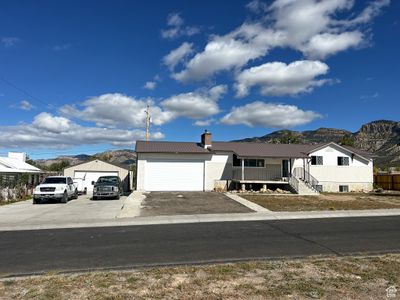 View of front facade featuring a mountain view and a garage and shop | Image 3