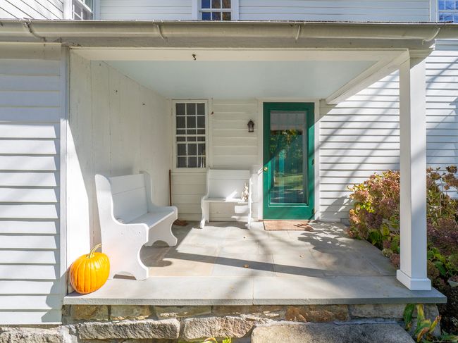 Covered porch is both practical and charming. | Image 4