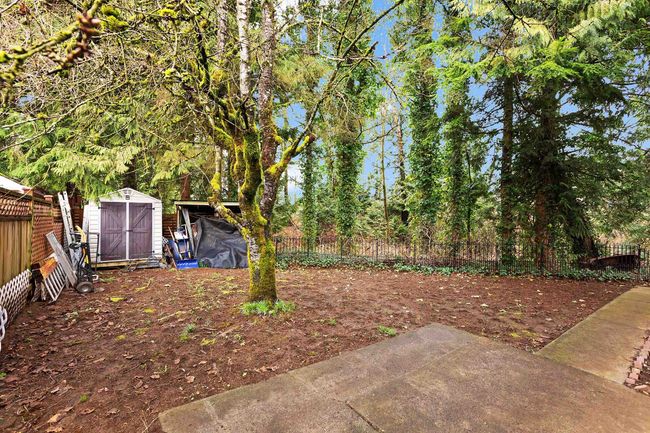 View of yard featuring a storage unit and a patio | Image 25