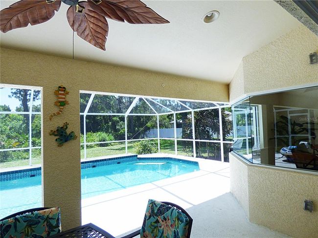 lanai with fan and recessed light, 3 panel aquarium window where dinette is located | Image 28