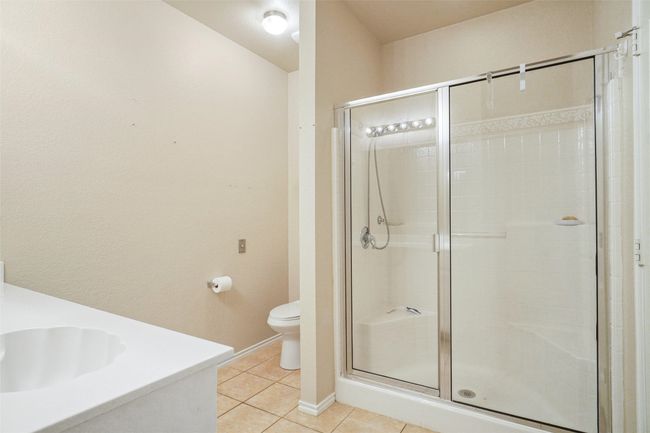 Primary Bathroom with vanity, toilet, tile patterned flooring, and a shower stall | Image 19