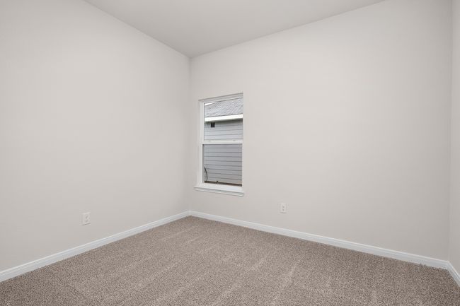 Carpeted empty room featuring baseboards and vaulted ceiling | Image 6