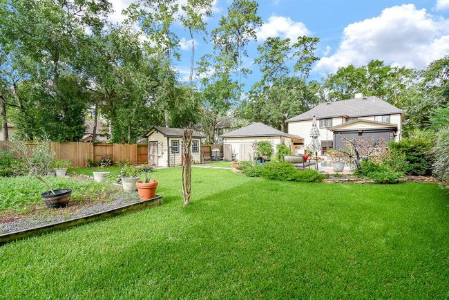 There is a ample room to run free on the grass and to grow your favorite foods in this wonderfully expansive yard! | Image 47