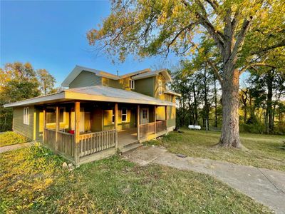 View of front facade featuring a porch and a front lawn | Image 2