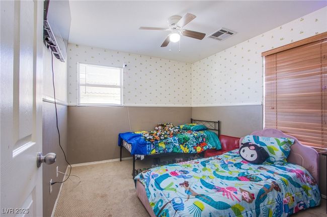 Bedroom featuring wallpapered walls, carpet floors, a ceiling fan, and baseboards | Image 11