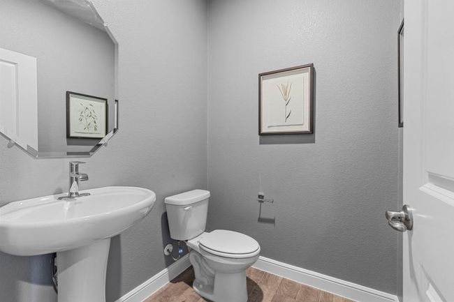 Half bath featuring wood finished floors and toilet | Image 14