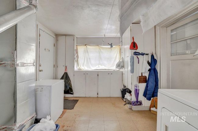 Washroom featuring light floors and washer / clothes dryer | Image 18