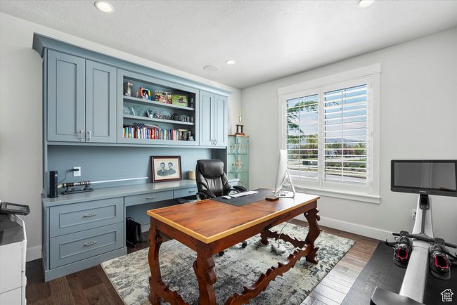 Office space with a textured ceiling, baseboards, recessed lighting, and dark wood-style floors | Image 5