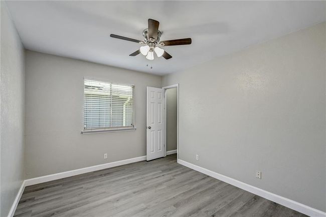 Empty room featuring baseboards, a ceiling fan, and wood finished floors | Image 12